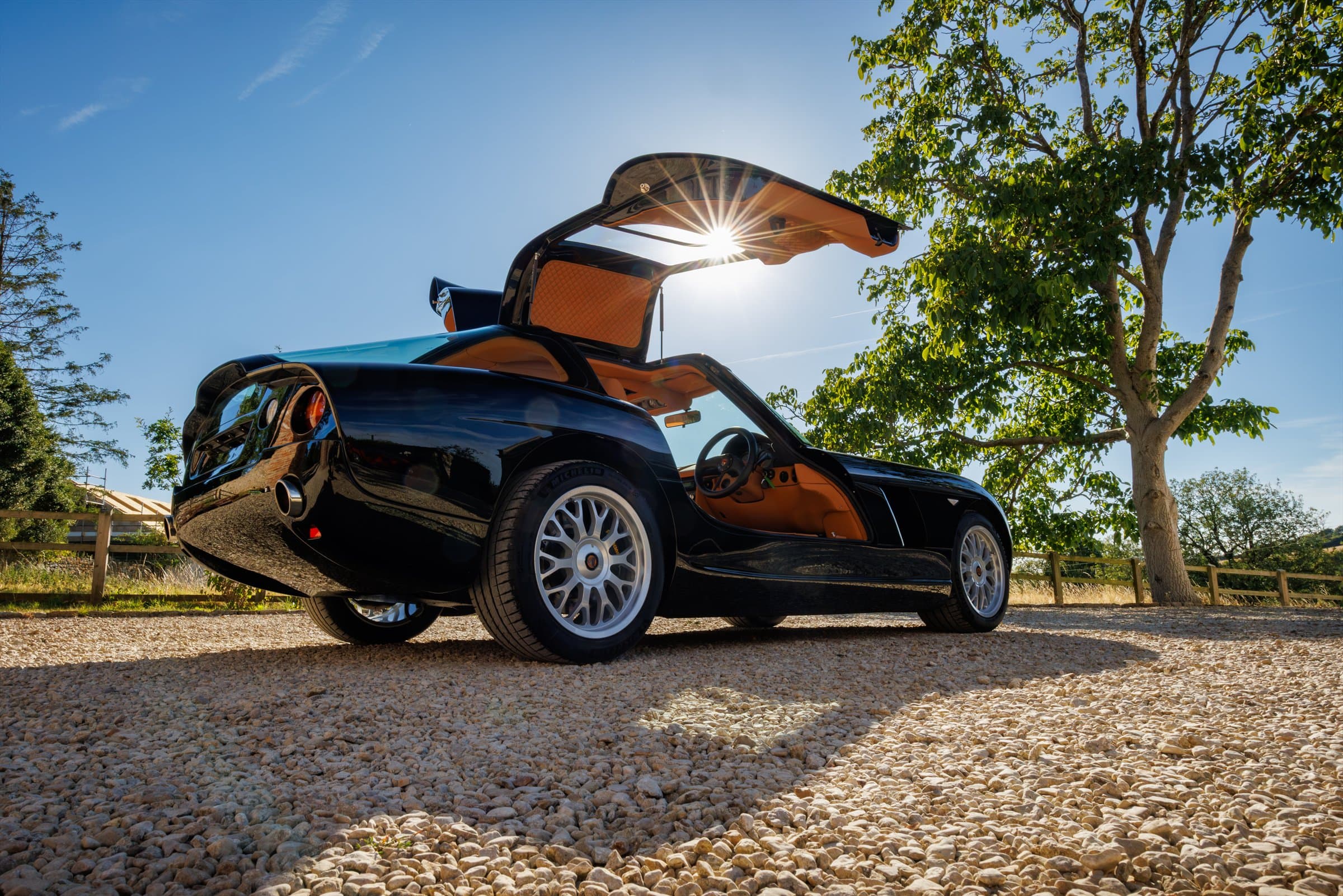 Full new-build black Bristol Fighter viewed from the rear with its gullwing door raised