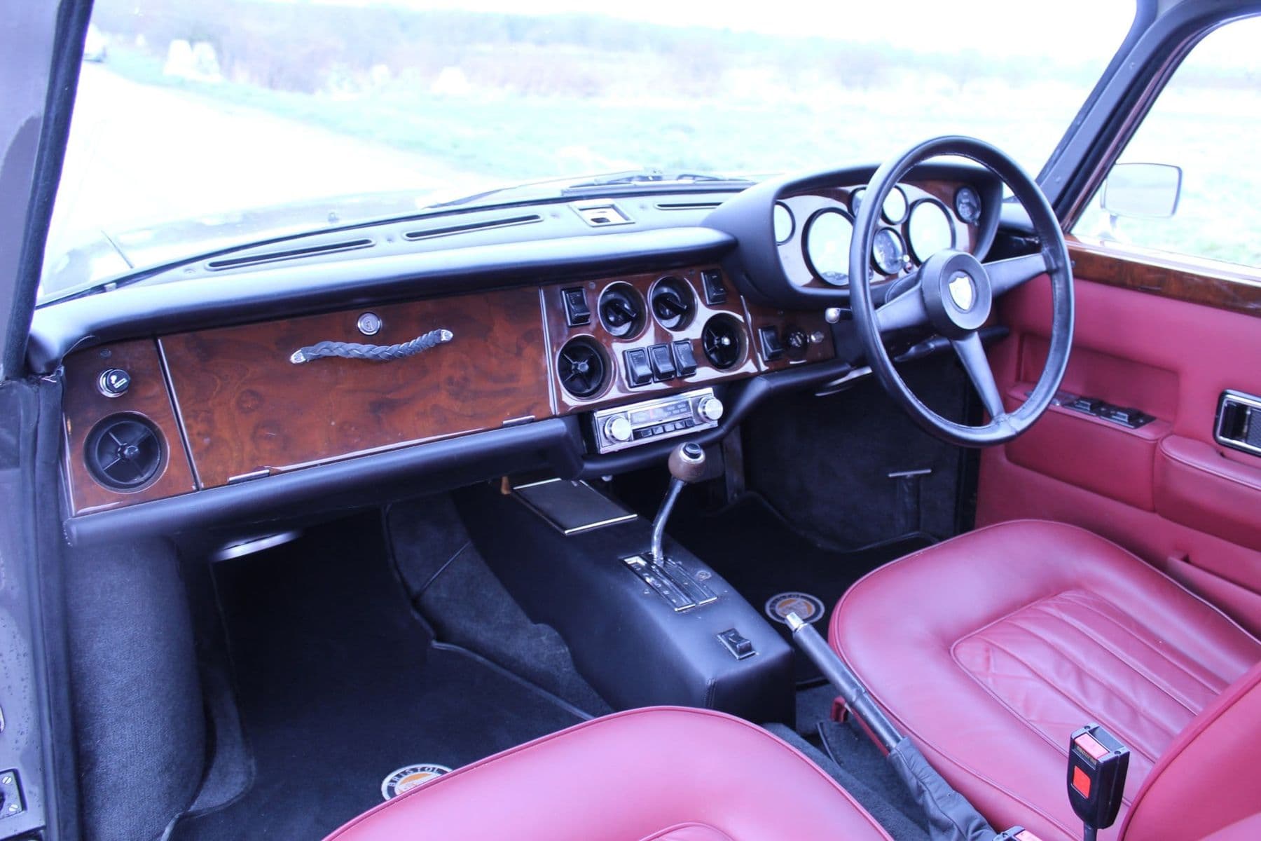 Bristol 411 cabin with red hide upholstery and a burr walnut dashboard